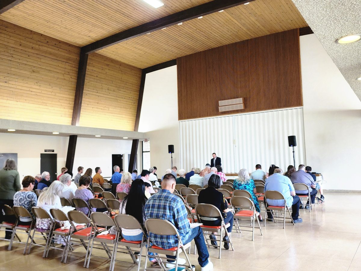 Adults seated in the Social Hall listening to teaching during Equipping Hour